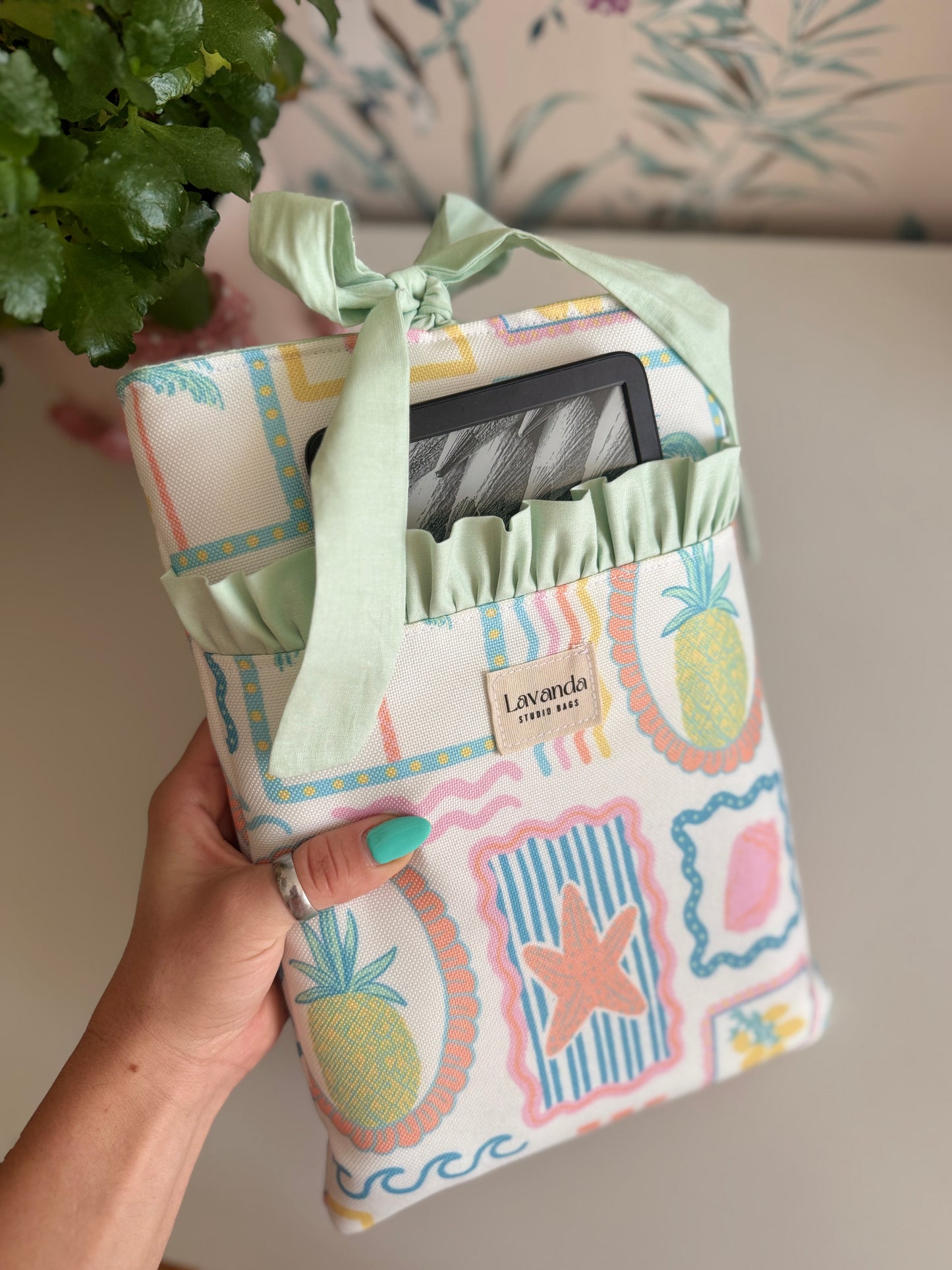 Book sleeve with bow and front pocket