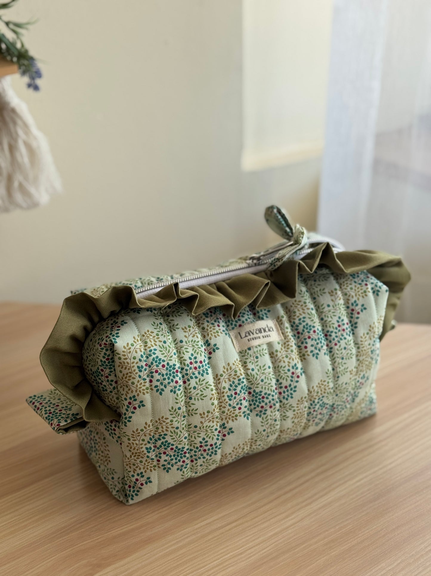 a.Cosmetic bag berrytangle and green colour.