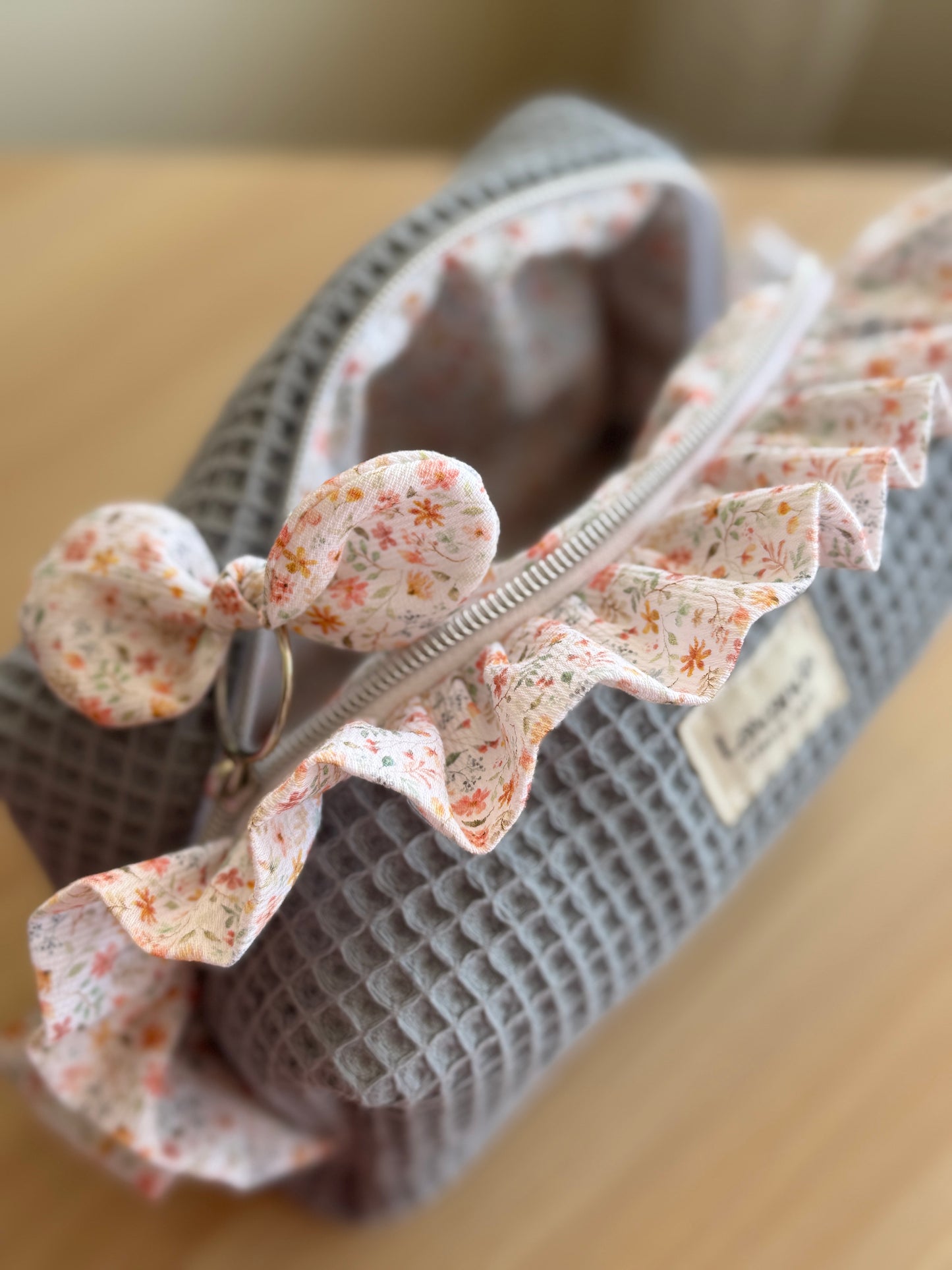 a.Cosmetic bag fresia grey blue waffle and mini flowers.