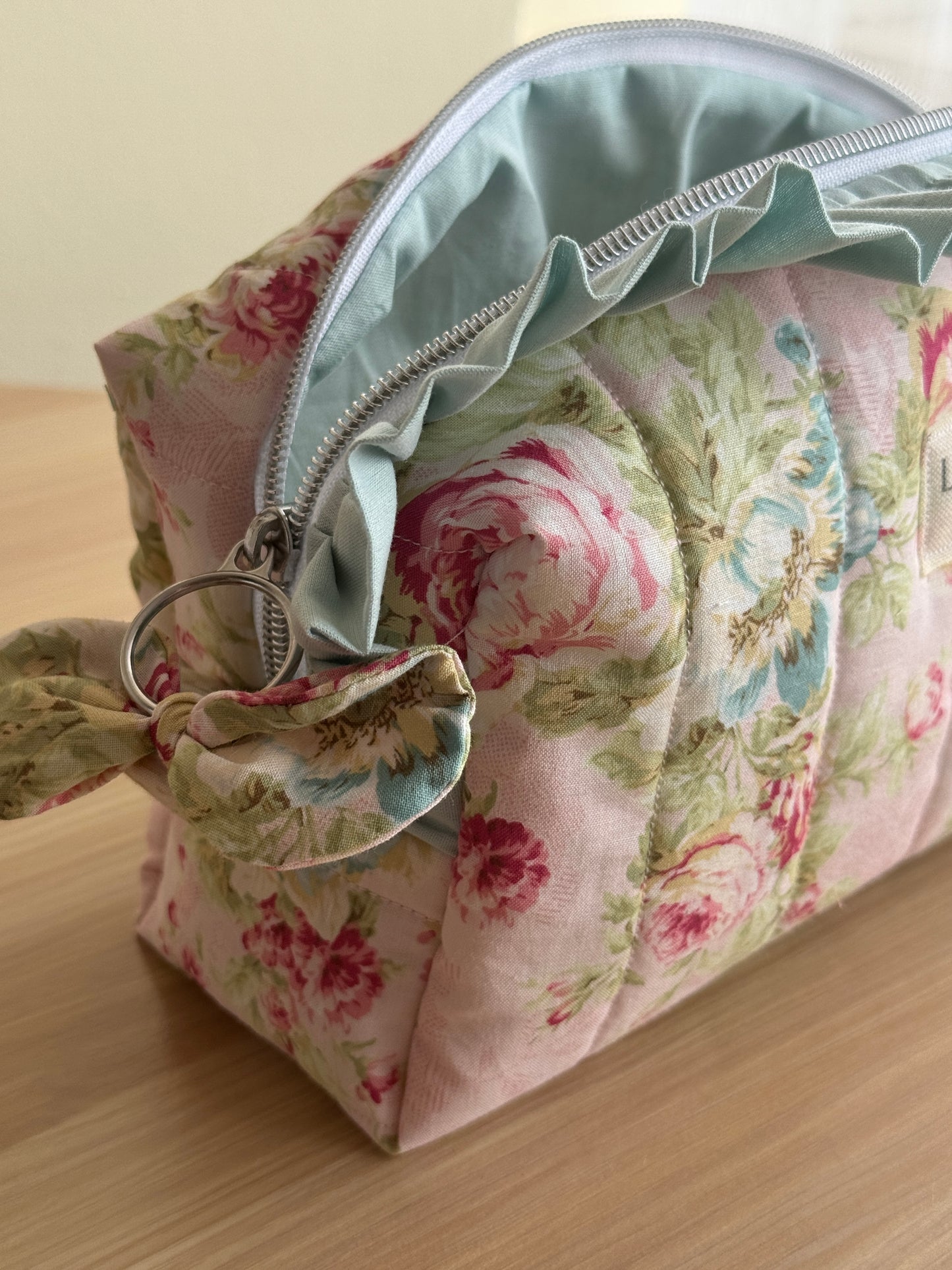 a.Cosmetic bag floral and ruffle. “garden of memories”