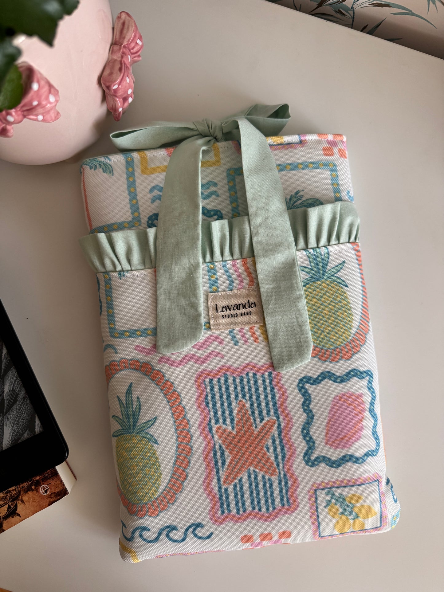 Book sleeve with bow and front pocket