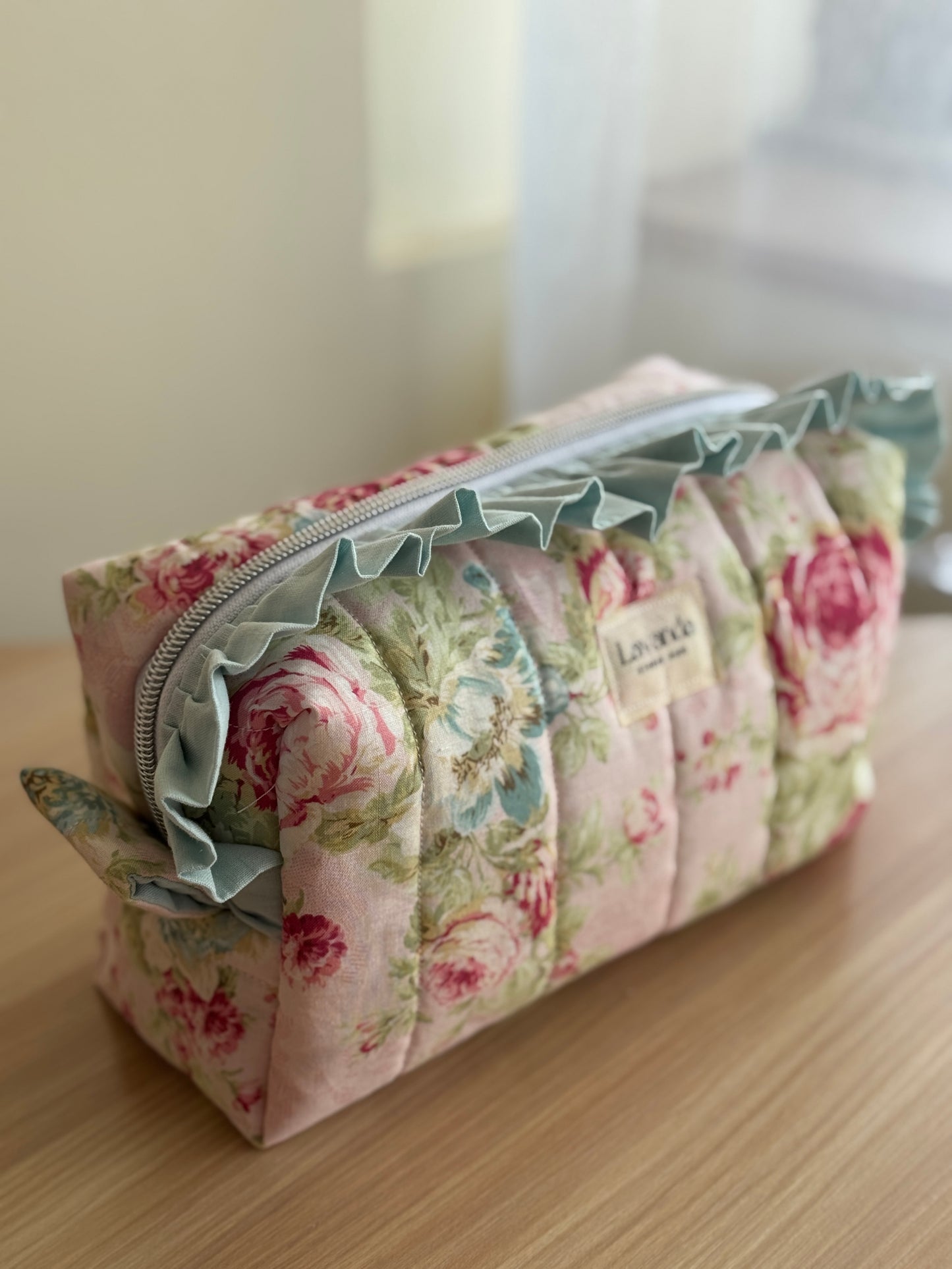 a.Cosmetic bag floral and ruffle. “garden of memories”