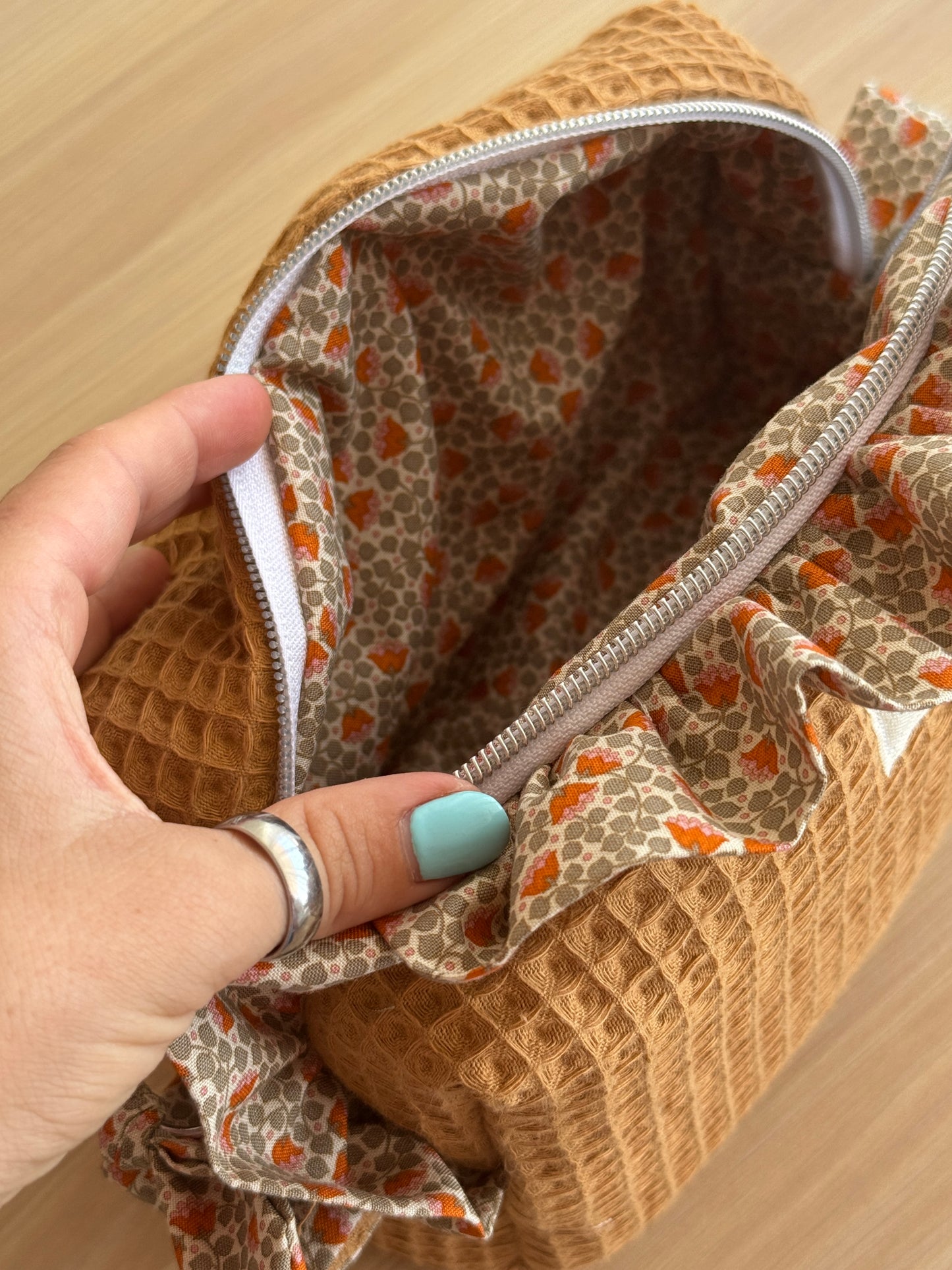 a.Cosmetic bag fresia orange flowers.