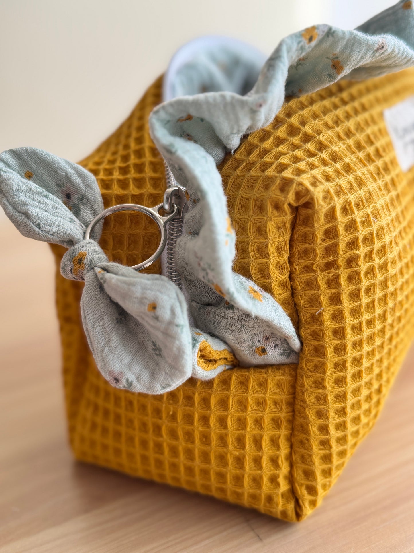 a.Cosmetic bag fresia yellow waffle and mini flowers.