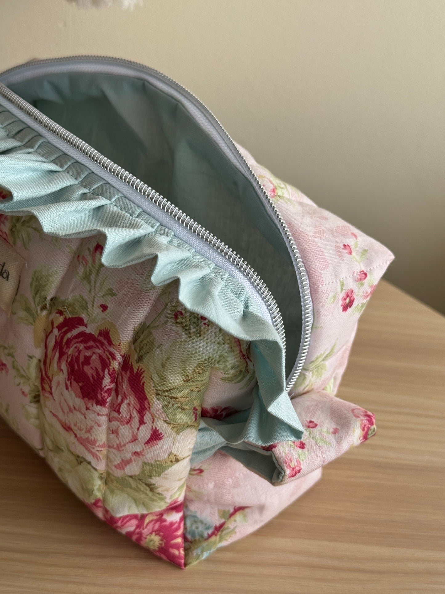 a.Cosmetic bag floral and ruffle. “garden of memories”