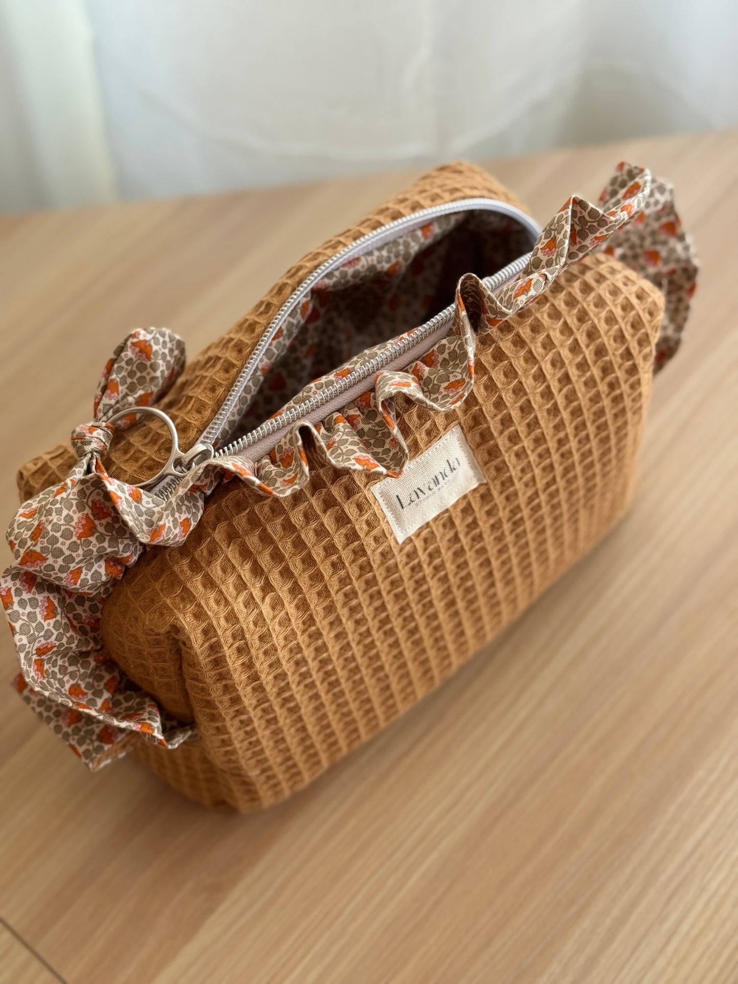 a.Cosmetic bag fresia orange flowers.