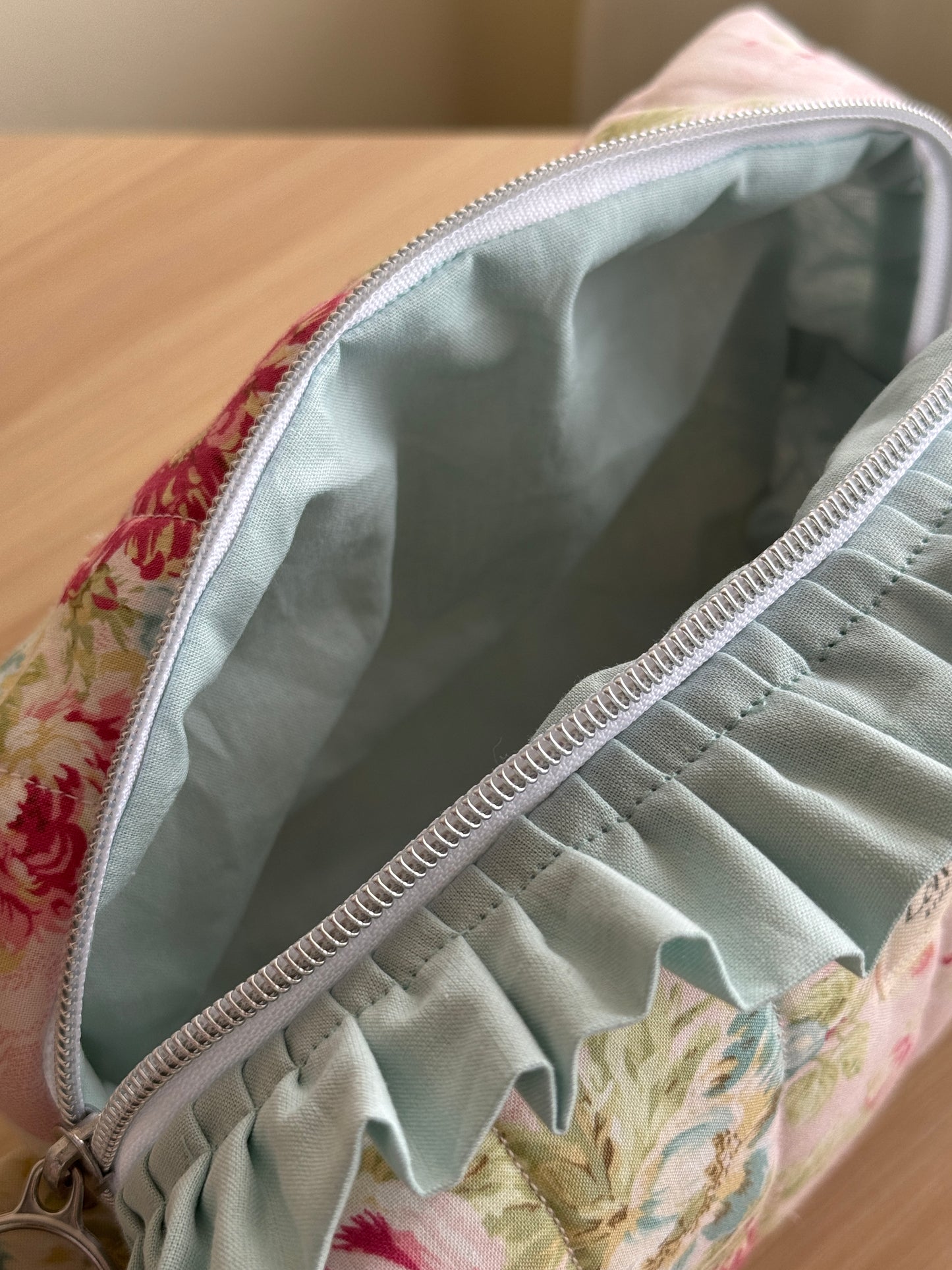 a.Cosmetic bag floral and ruffle. “garden of memories”
